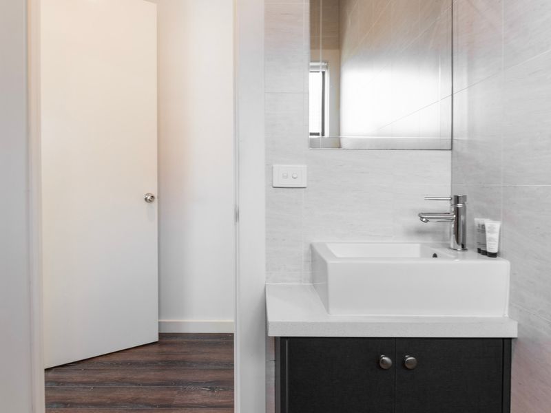 Clean and simple vanity and mirror within ensuite bathroom