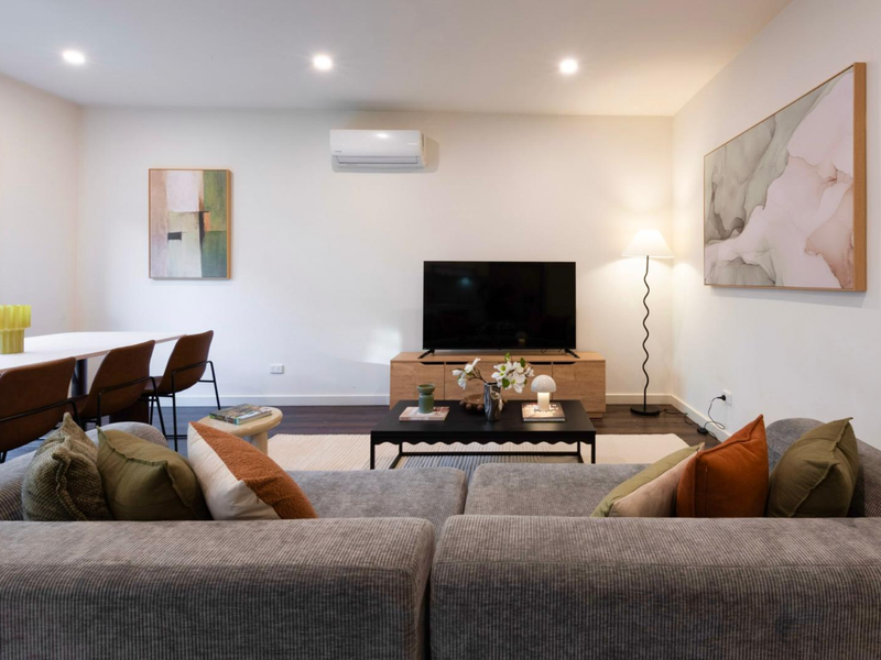 Open-plan living and dining area designed for comfort, featuring stylish furnishings and plenty of natural light.
