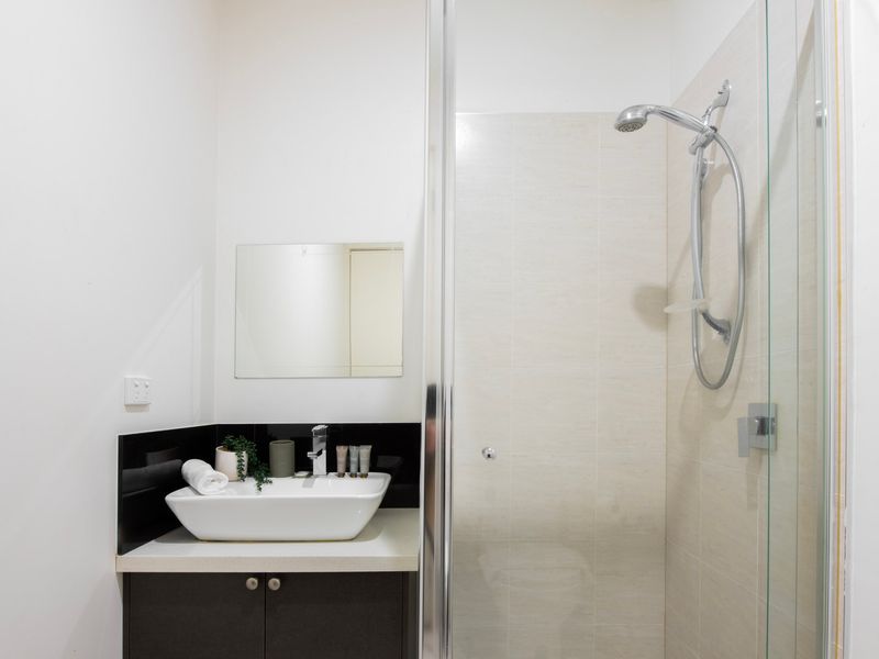 Contemporary bathroom complete with vanity and walk-in shower.