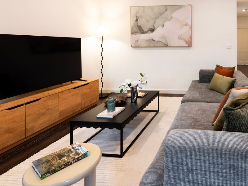 Comfortable lounge room complete with a large smart TV and cosy seating for movie nights in.