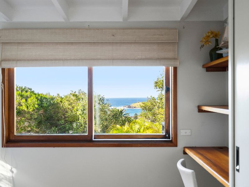 Expansive windows framing beautiful natural light and scenic views.