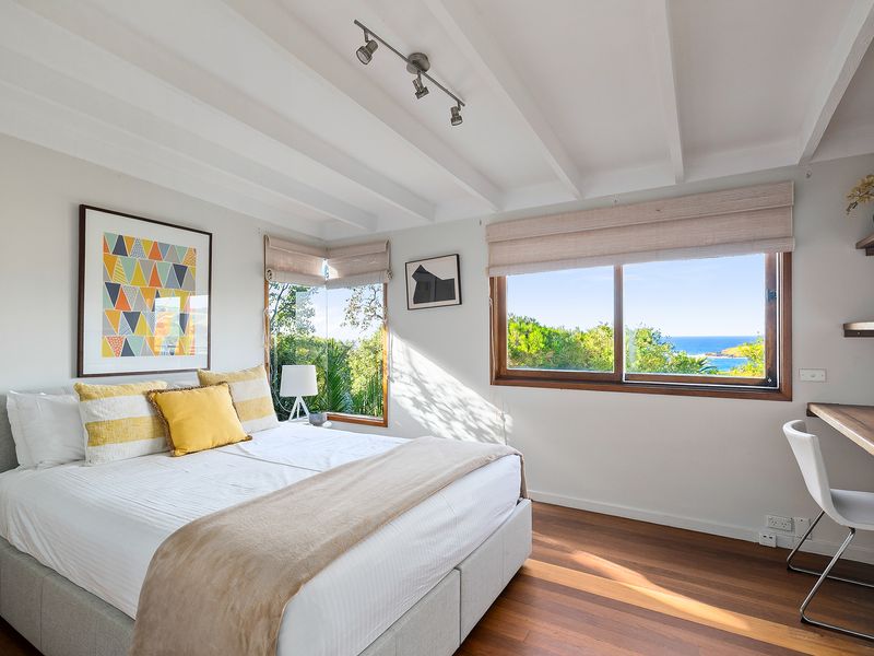 Light-filled bedroom retreat with windows that bring the outdoors in.