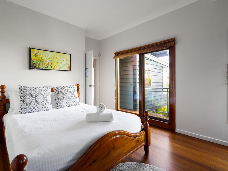 A bright white bedroom designed for rest and relaxation.