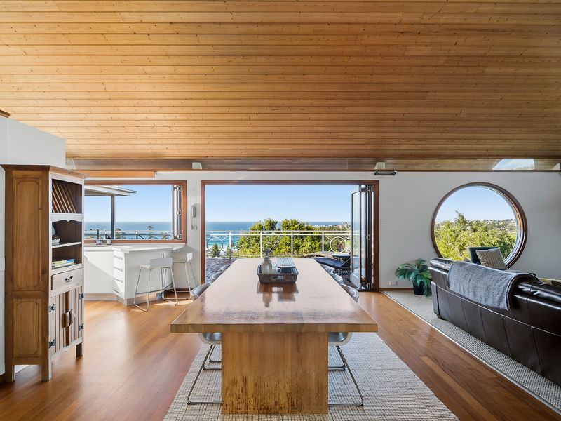 A spacious kitchen table framed by open terrace views and endless natural light.