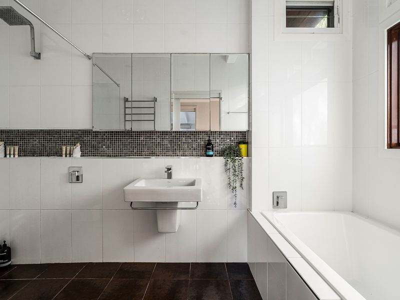 Refresh and recharge in this light-filled bathroom with bathtub comfort.