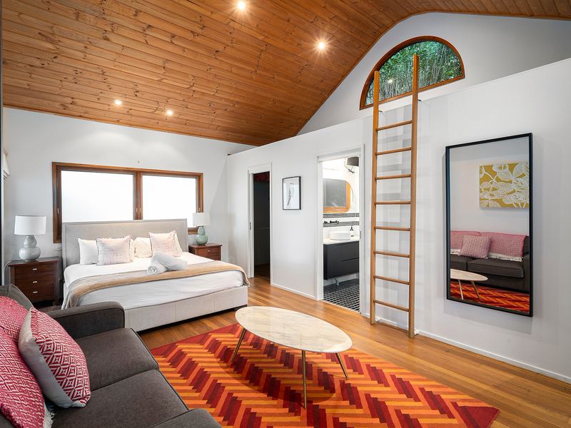 Stylish bedroom sanctuary with a sofa perfect for unwinding in comfort.