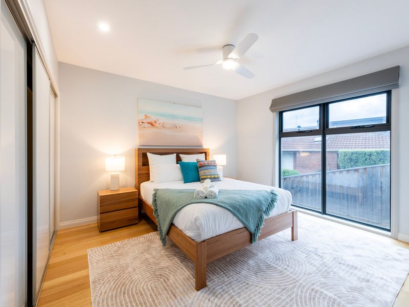 Comfortable queen bedroom with soft styling and modern finishes