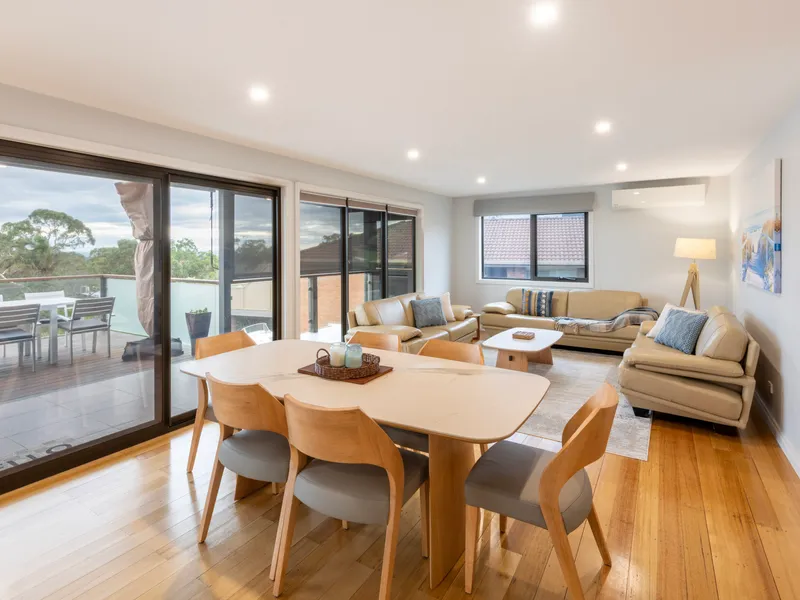 Bright open-plan living and dining with modern coastal styling