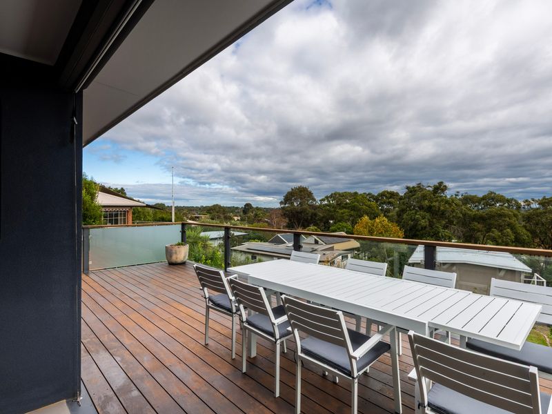 Spacious elevated deck with outdoor dining and BBQ area