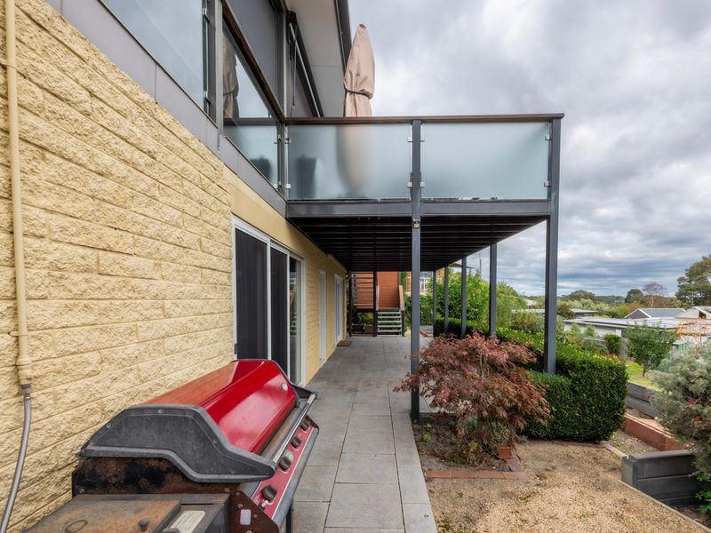 Covered patio with low-maintenance surrounds and BBQ for entertaining.