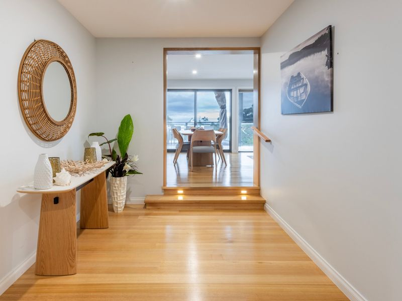 Spacious entry and hallway with warm timber flooring