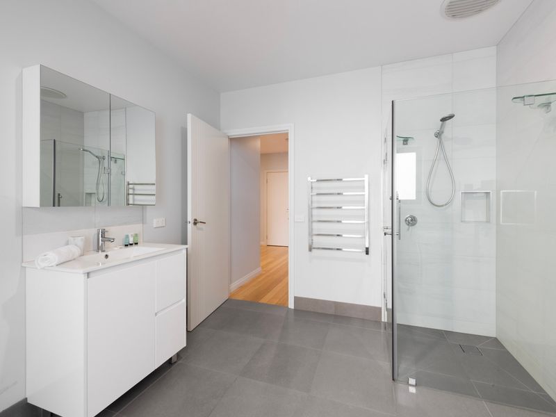 Spacious main bathroom with glass shower and contemporary design