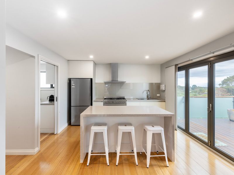 Large central kitchen with island bench and breakfast bar seating
