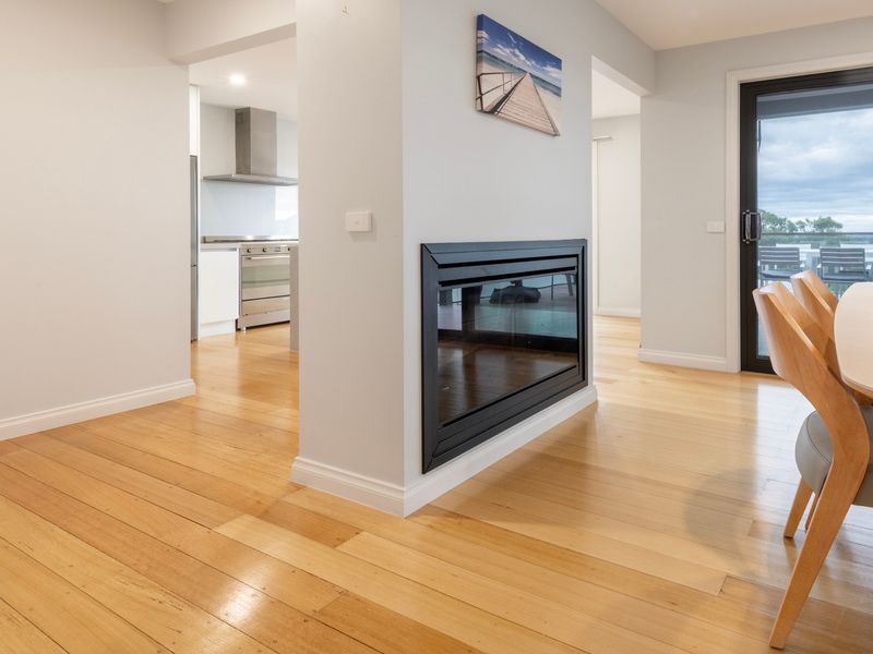 Dining area with gas fireplace and large windows