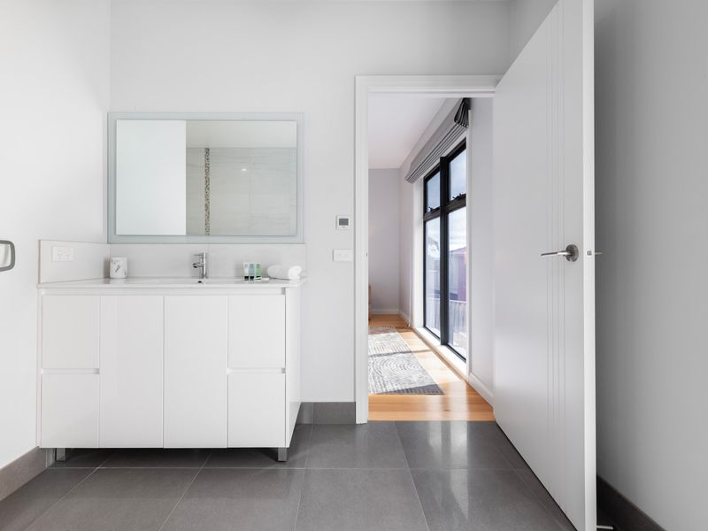 Light-filled ensuite bathroom with clean, modern styling