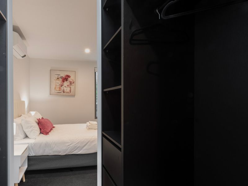 Spacious primary bedroom with comfortable bedding and a calm, relaxing atmosphere