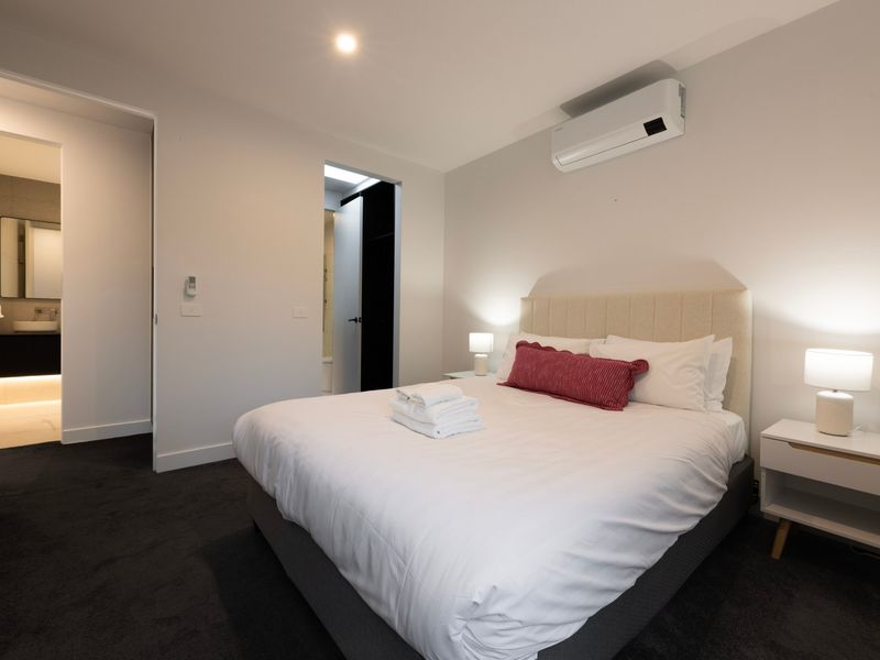 Spacious primary bedroom with comfortable bedding and a calm, relaxing atmosphere
