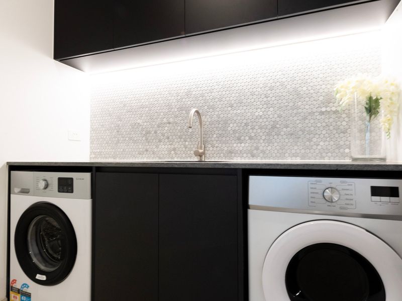 Fully equipped internal laundry with washer, dryer and essential amenities for longer stays