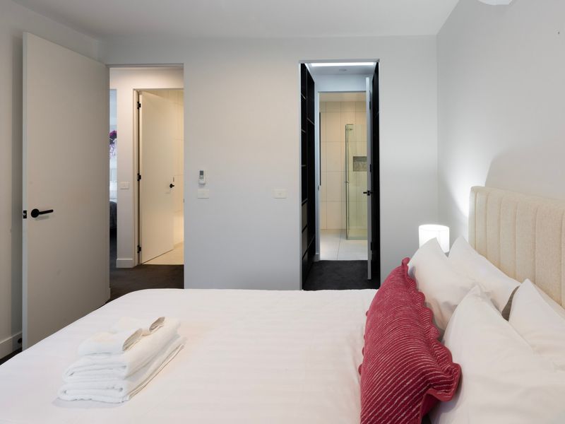 Spacious primary bedroom with comfortable bedding and a calm, relaxing atmosphere