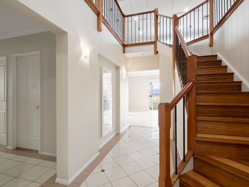 A striking staircase and open hallway create an impressive first impression from the moment you arrive.