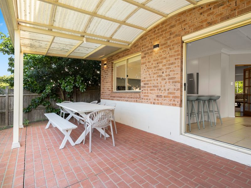 Relax under the covered alfresco area with outdoor seating and direct access to the kitchen.