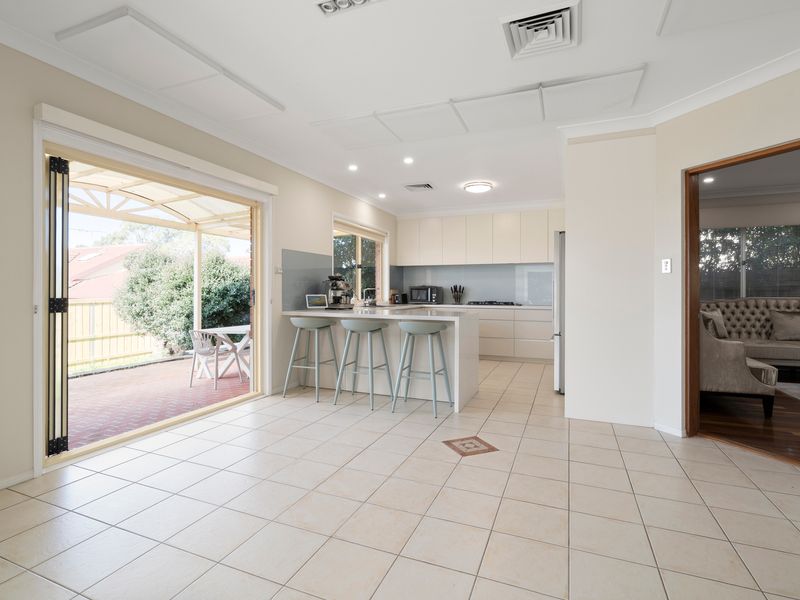 Open the sliding doors and enjoy seamless indoor-outdoor living from the bright dining area.