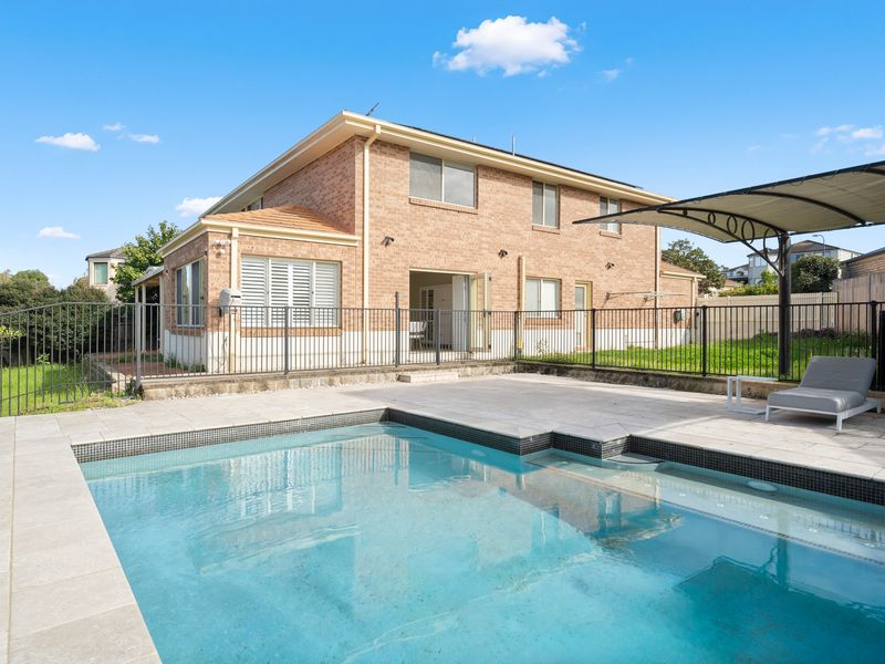 The spacious backyard and pool area provide plenty of room for everyone to enjoy the outdoors.