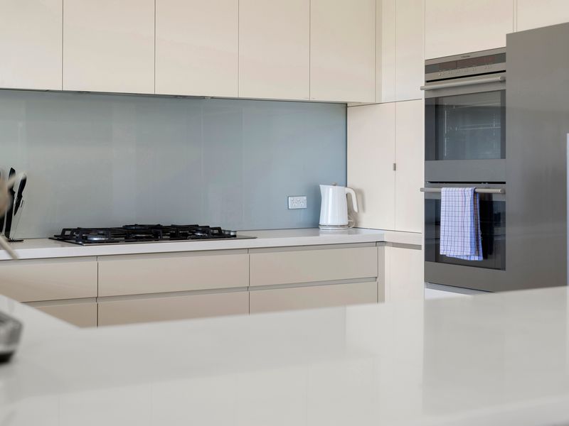 The contemporary kitchen offers generous bench space and quality appliances.