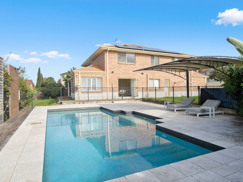 Take a refreshing dip in the private swimming pool surrounded by sun loungers and tropical landscaping.