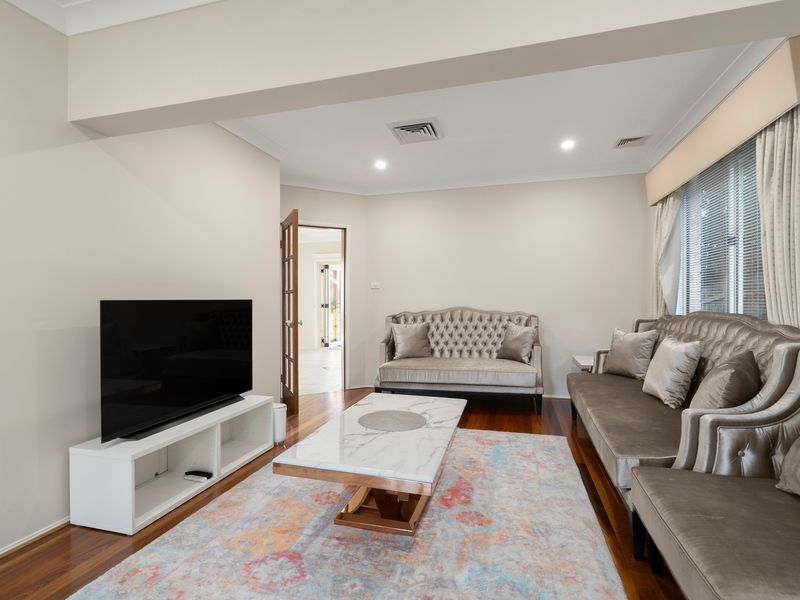 The cosy family room is perfect for movie nights and relaxing after a day by the pool.