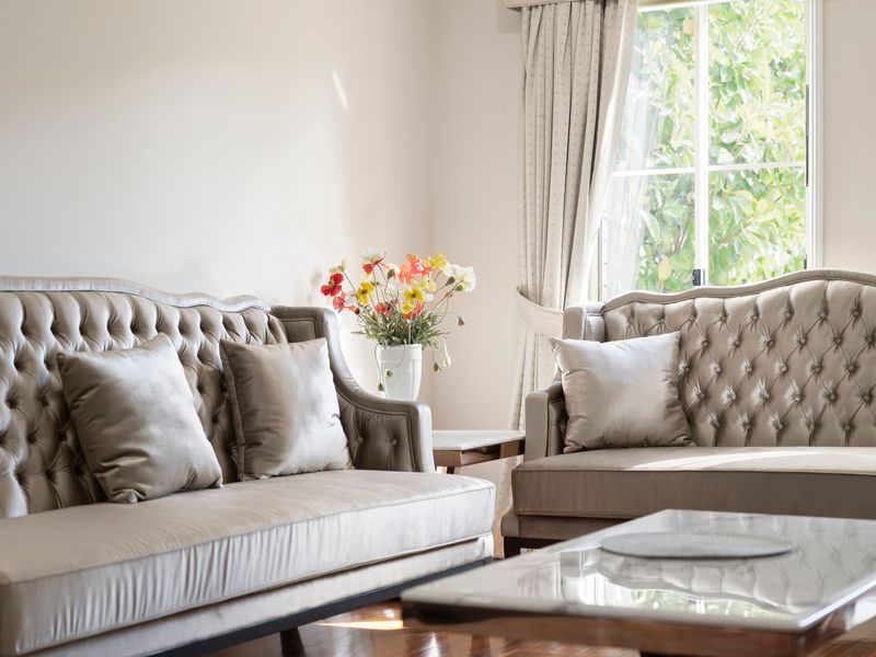 Elegant seating and large windows create a warm and inviting living space.