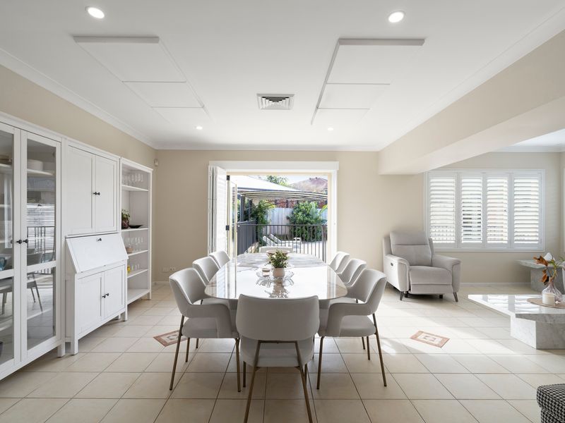 Gather around the elegant dining table in a light-filled space designed for shared meals and celebrations.