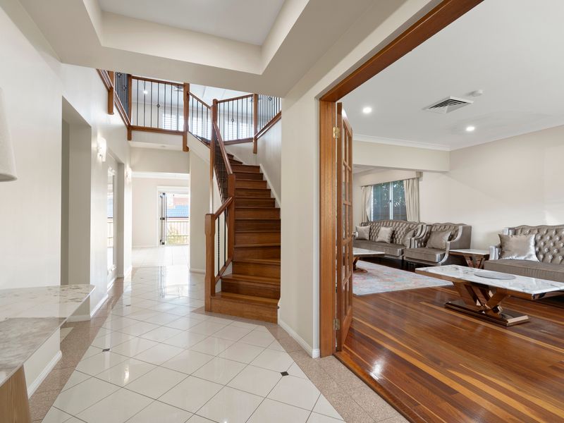 The grand entryway welcomes you with soaring ceilings, polished timber floors, and a sense of space.