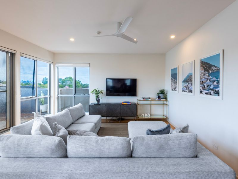 Large windows and sliding doors for natural light in the living room. 