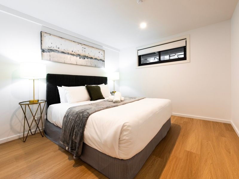 Main bedroom featuring a comfortable bed and storage for a restful and private stay.