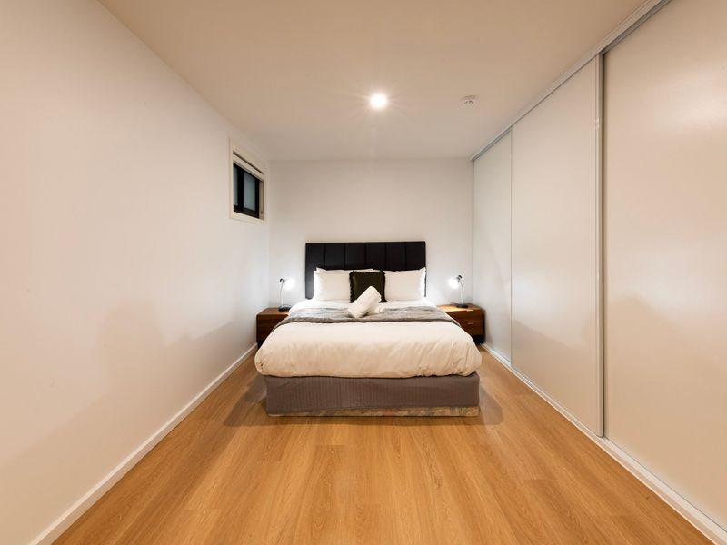 Second bedroom suited for additional guests, offering practical furnishings and a quiet setting.