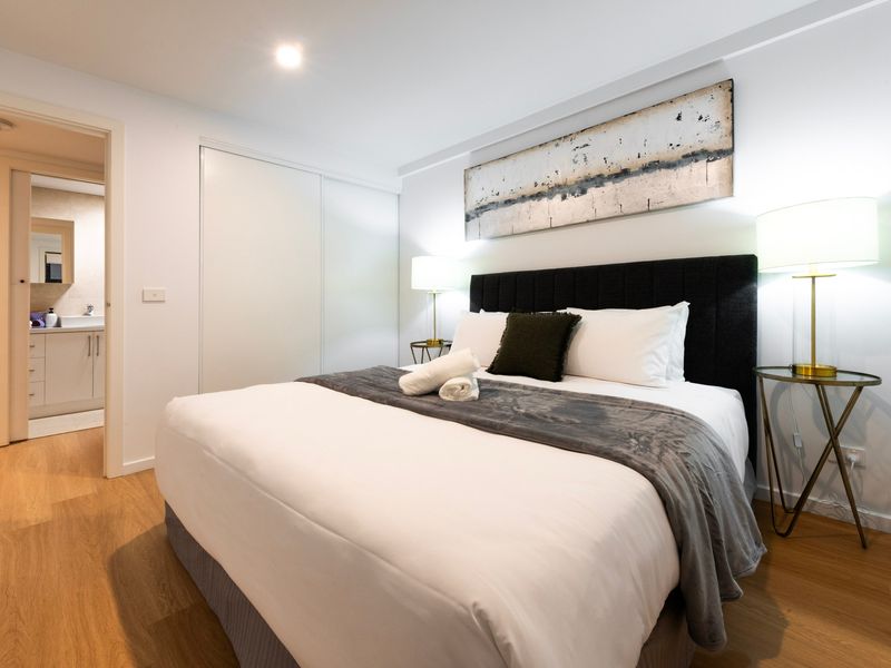 Main bedroom featuring a comfortable bed and storage for a restful and private stay.