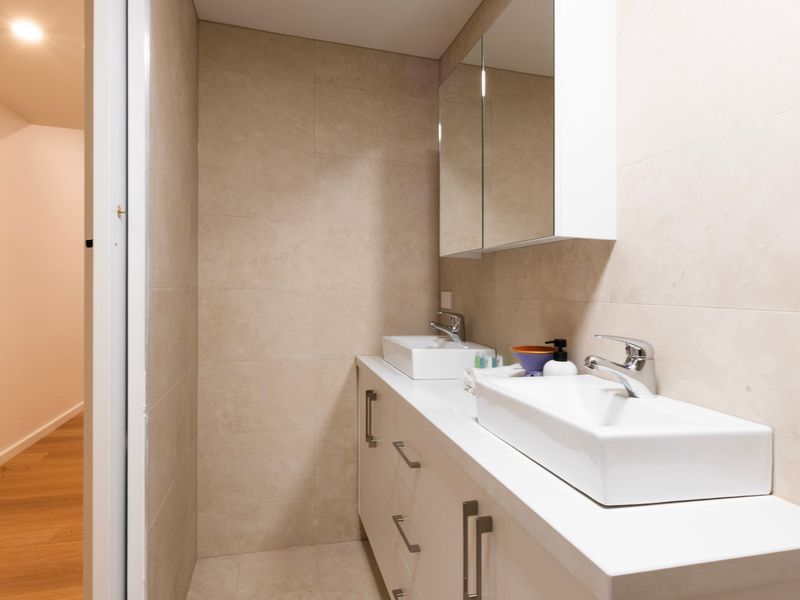 Functional bathroom with shower, vanity, and essential amenities provided.