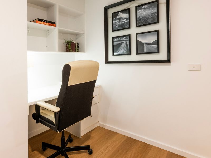 Comfortable bedroom setup featuring a dedicated desk and chair, along with a relaxed sitting area for reading, working, or unwinding during your stay.