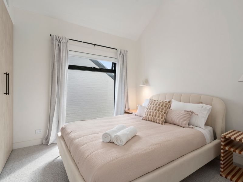 Bedroom with comfortable bedding and storage for longer stays