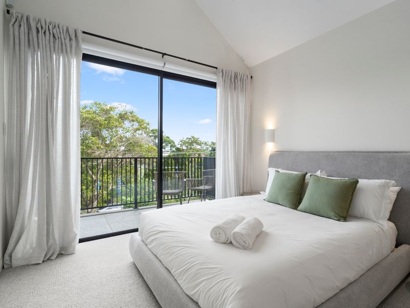 Bedroom with comfortable bedding and private patio