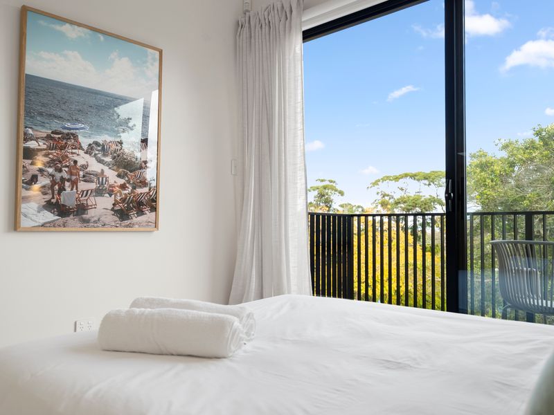 Bedroom with comfortable bedding and private patio