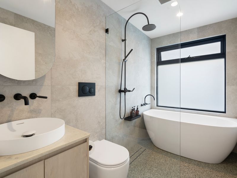 Well-appointed bathroom with shower and bath and quality finishes