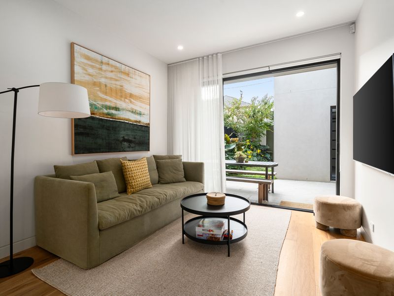 Open-plan living to backyard, wall mounted TV and comfortable lounge