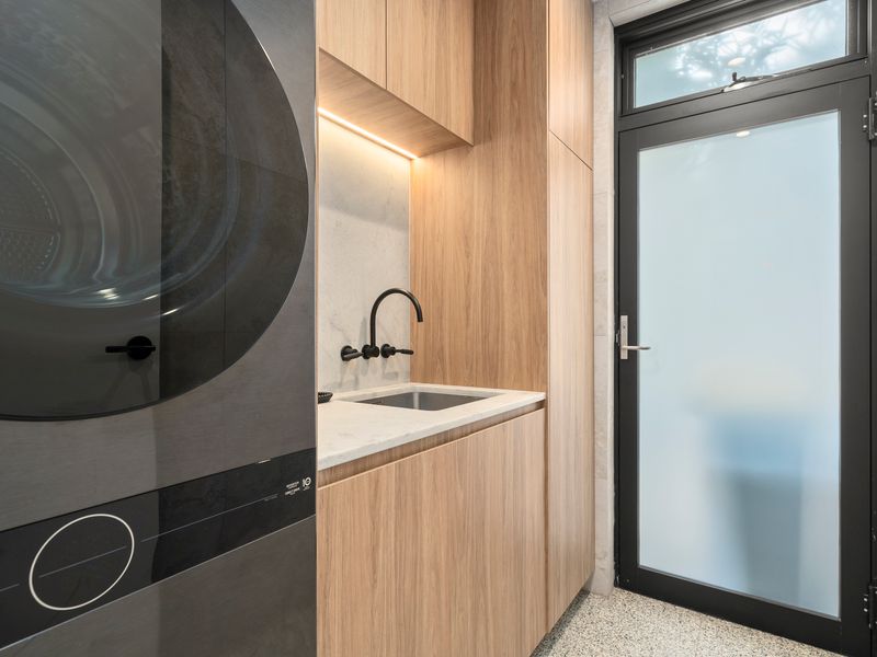 Dedicated laundry space with essential appliances for longer stays