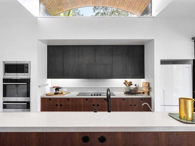 Open kitchen flowing into nature-filled living