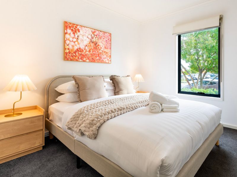 Thoughtfully styled bedroom with bedside lighting and storage