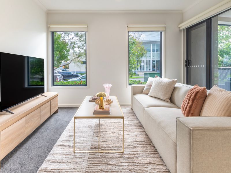Bright open plan living with comfortable seating and smart TV