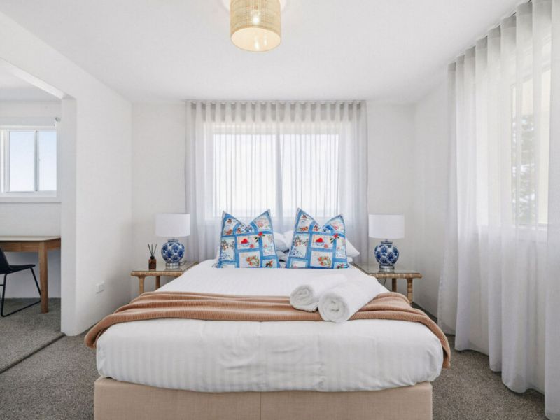 Soft tones and comfortable bedding create instant relaxation.