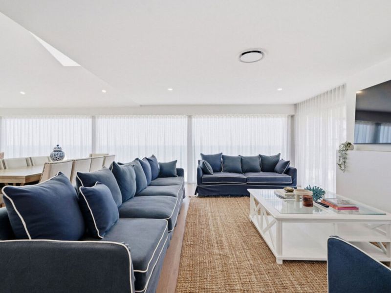 Relax in the bright living room overlooking the sea.